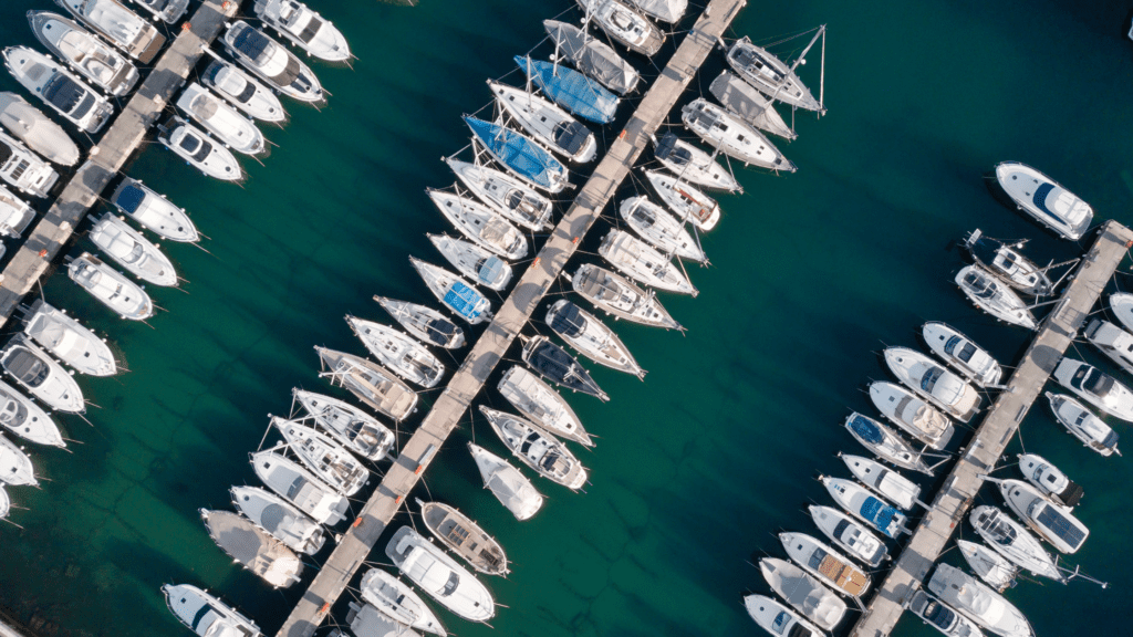 birdseye view of a busy marina with yachts harboured