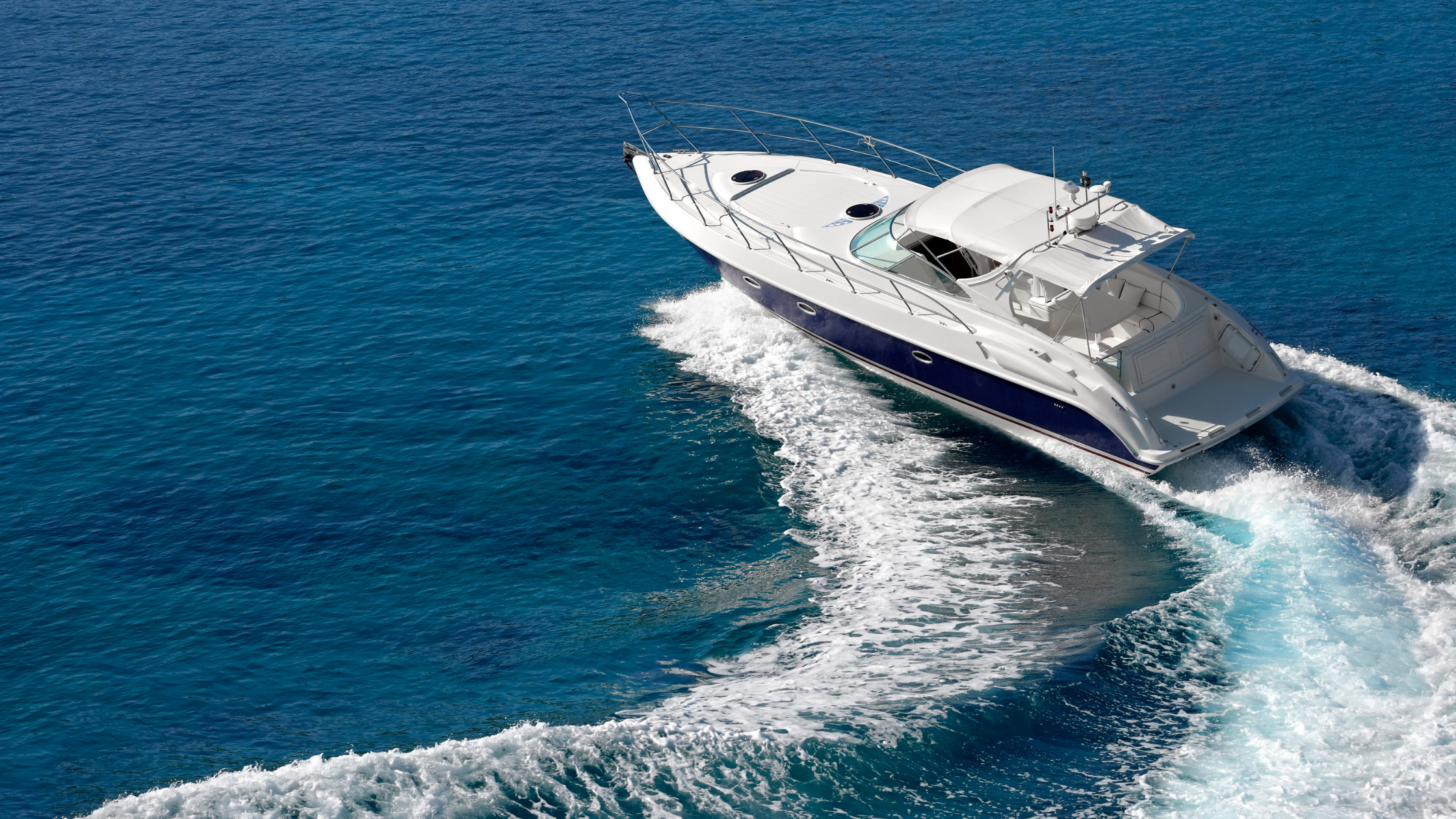 Motor cruiser turning at speed in the open water