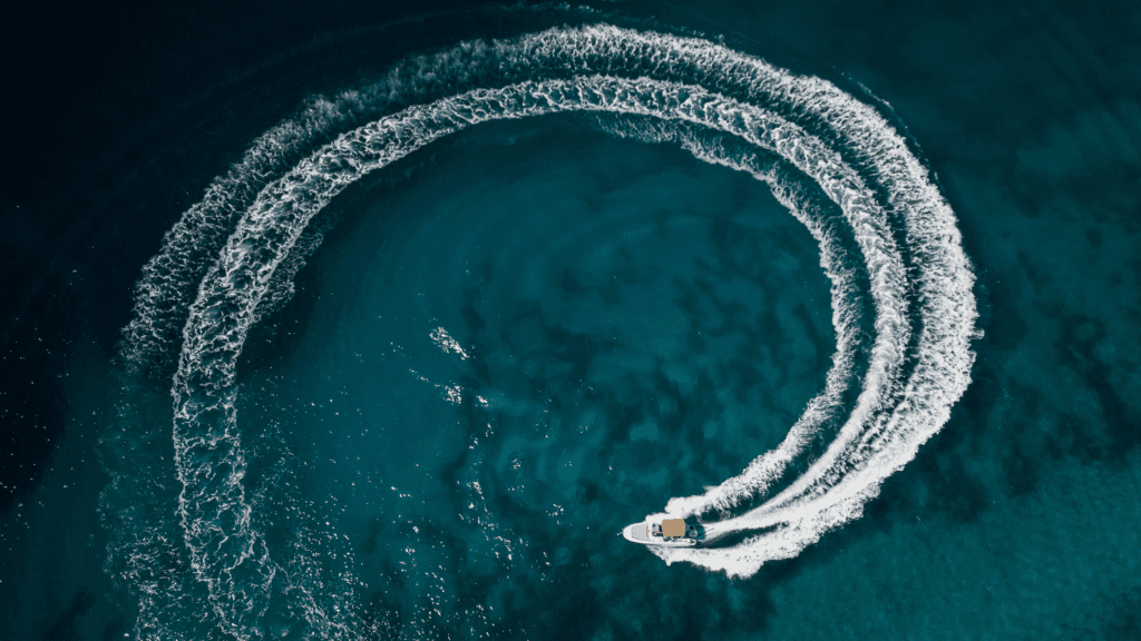 motor yacht gliding in a circular motion on the open water
