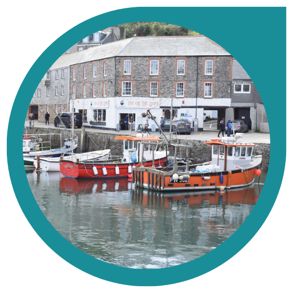 orange fishing boats moored in a British harbour