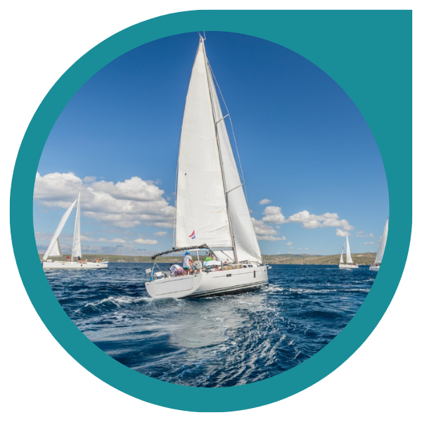 white yachts with sails on the open water